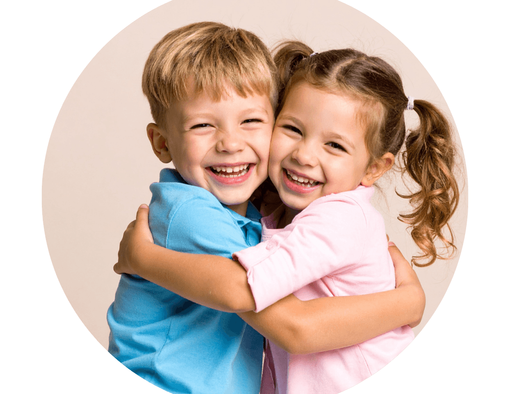 Two women hugging and smiling joyfully while taking a selfie together. 