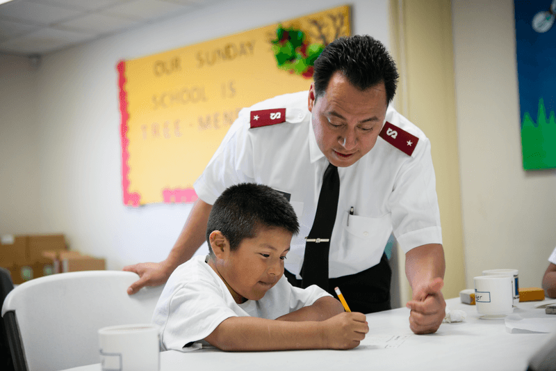 Young boy receiving help on his homework.